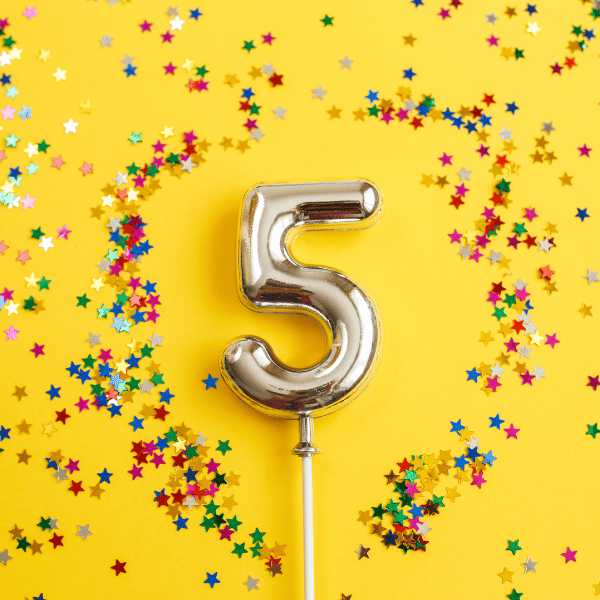 The number five surrounded by confetti